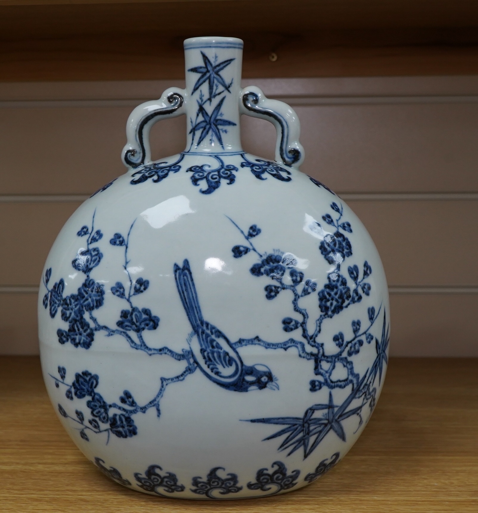A Chinese blue and white two handled moon flask, decorated with birds on on branches, 29cm high. Condition - good